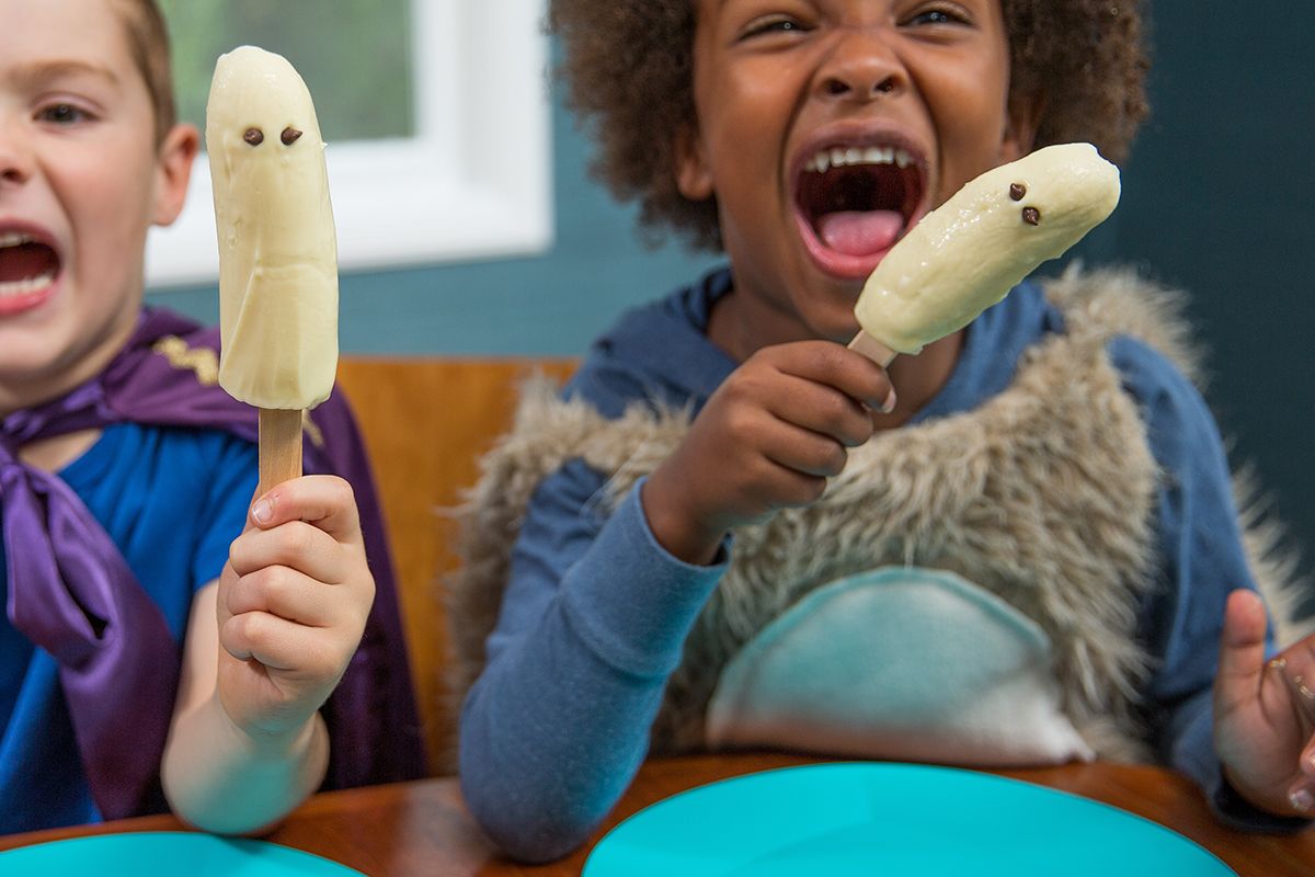 two kids excited with ghost bananas